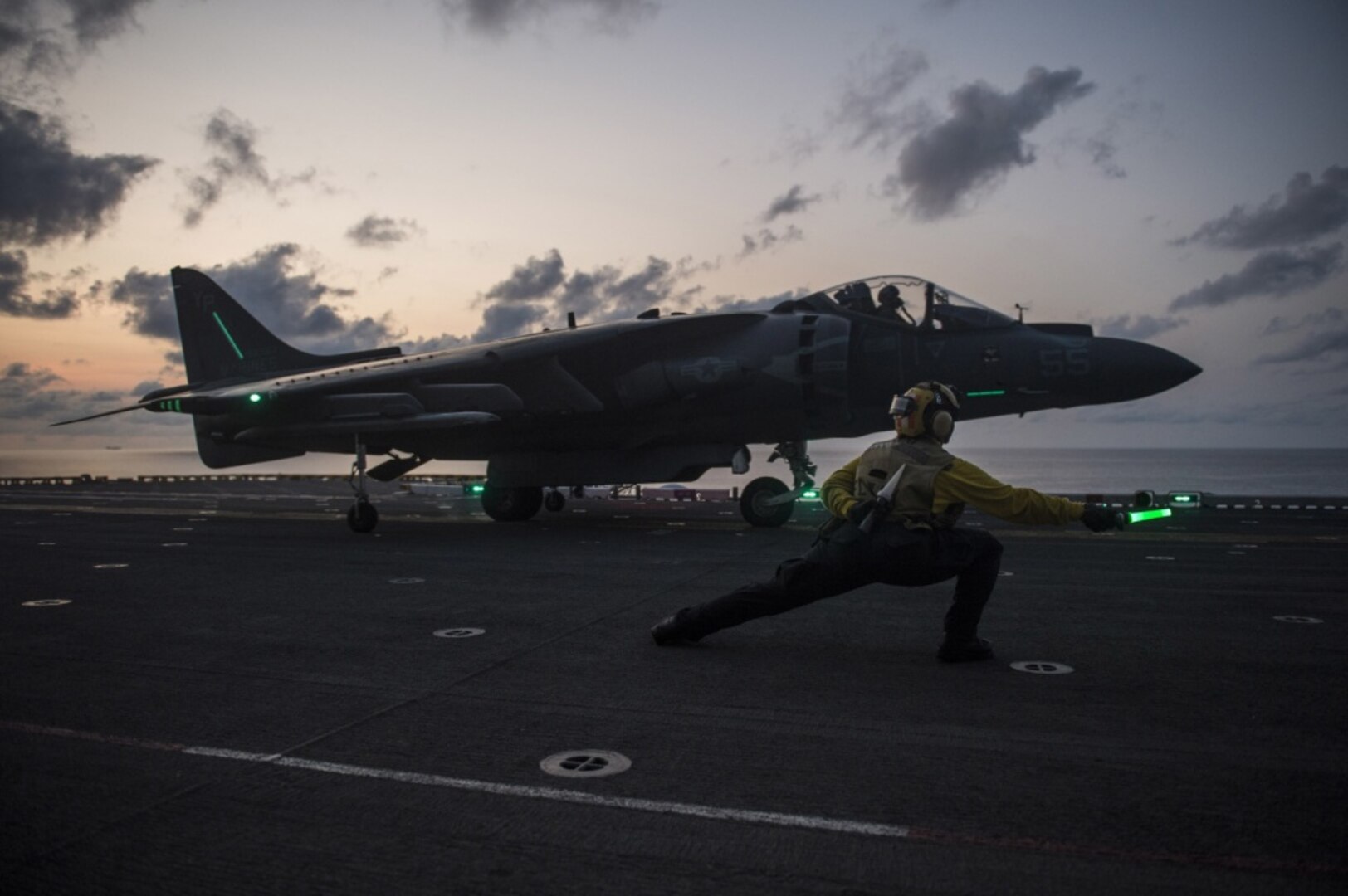 Aviation Boatswain™s Mate (Handling) 2nd Class Morgan Jackson, from Los Angeles, gives the signal for an AV-8B Harrier, assigned to the Ridge Runners of Marine Medium Tiltrotor Squadron (VMM) 163, to take off from the flight deck of the amphibious assault ship USS Makin Island (LHD 8), April 12, 2017. Makin Island, the flagship for the Makin Island Amphibious Ready Group, with the embarked 11th Marine Expeditionary Unit, is operating in the Indo-Asia-Pacific region to enhance amphibious capability with regional partners and to serve as a ready-response force for any type of contingency. 