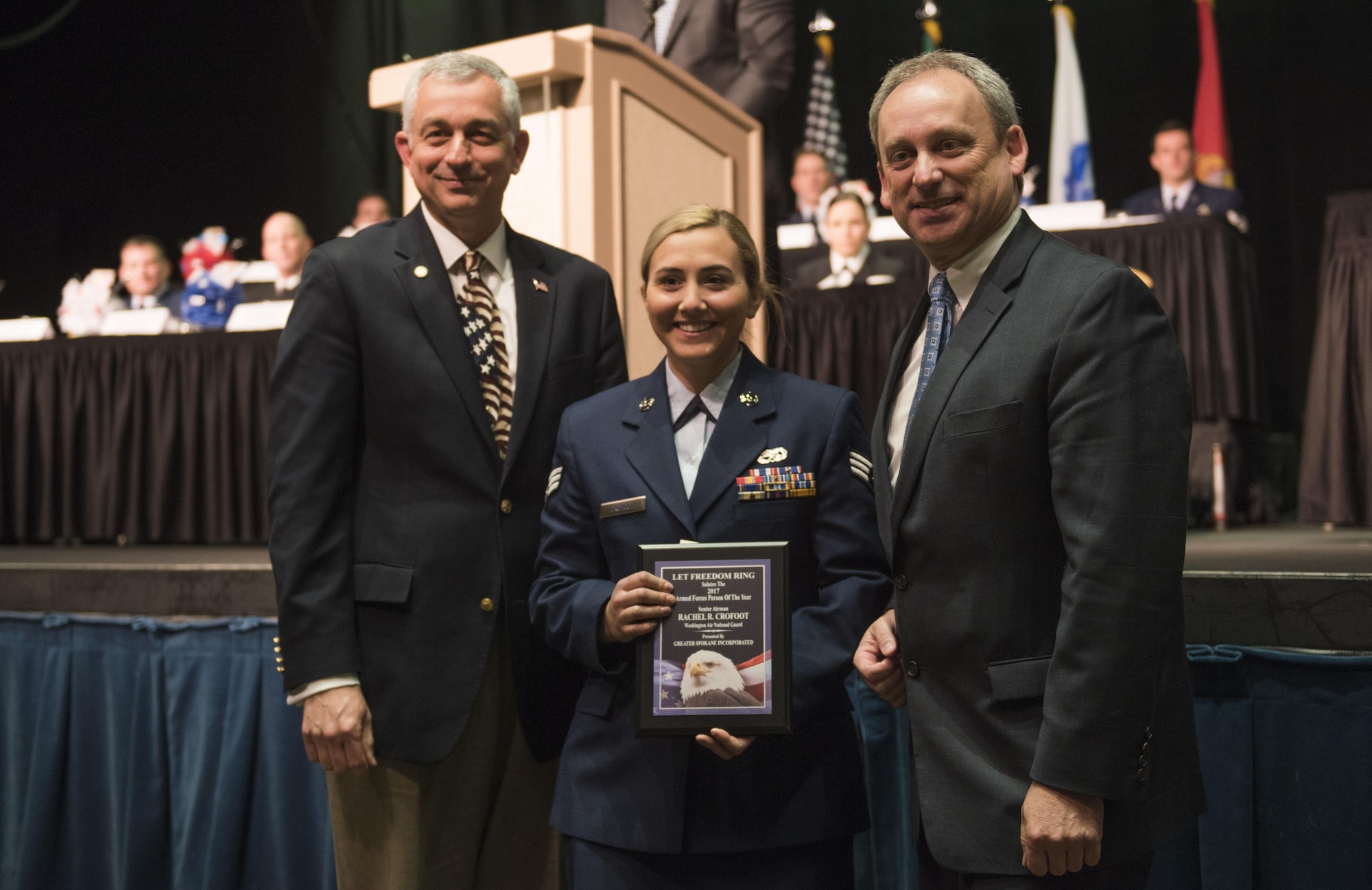 Senior Airman Rachel Crofoot, 141st Aircraft Maintenance Squadron crew chief, receives the 2017 Armed Forces Persons of the Year award, category Guard/Reserve E-1 through E-4, from Todd Mielke, Greater Spokane Incorporated CEO, and retired Brigadier General Roger Watkins, during the 61st annual Let Freedom Ring breakfast April 14, 201, at Northern Quest Casino in Spokane, Washington. The event honored military members from all branches, and recognized the Armed Forces Persons of the Year. (U.S. Air Force photo/Airman 1st Class Sean Campbell)