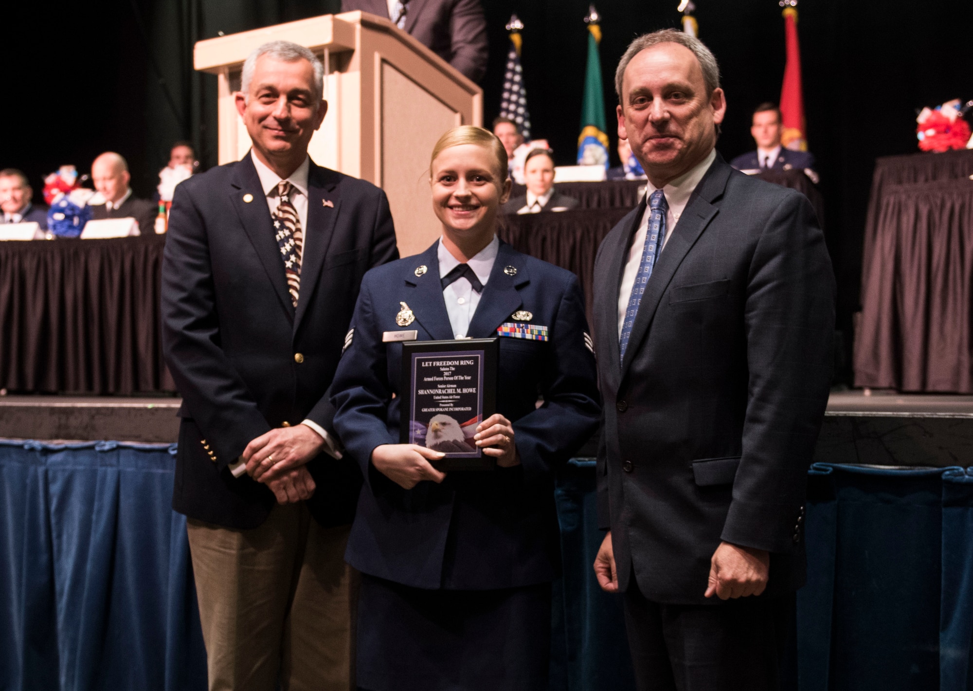 Senior Airman Rachel Crofoot, 141st Aircraft Maintenance Squadron crew chief, receives the 2017 Armed Forces Persons of the Year award, category Guard/Reserve E-1 through E-4, from Todd Mielke, Greater Spokane Incorporated CEO, and retired Brigadier General Roger Watkins, during the 61st annual Let Freedom Ring breakfast April 14, 201, at Northern Quest Casino in Spokane, Washington. The event honored military members from all branches, and recognized the Armed Forces Persons of the Year. (U.S. Air Force photo/Airman 1st Class Sean Campbell)