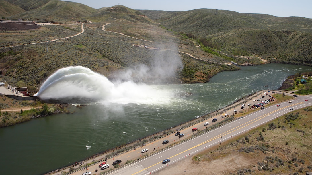 View of the "Rooster Tail", Lucky Peak Dam, April 29, 2012, Boise, Idaho. A popular springtime attraction is the "Rooster Tail" which results from the discharge of water through the original release structures of the dam under pressure from the lake above.  Using a "flip bucket" to direct the spray high into the air, the erosive, scouring force of the water is greatly dissipated as it rises, rests and slowly falls back to the stream channel.
The Rooster Tail only uses water from large releases required for flood risk management that exceed powerhouse capacity, thus no water is wasted for the display.   
It occurred daily until 1986 when construction of the Lucky Peak Power Plant Project started.  