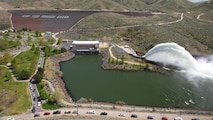 View of the "Rooster Tail", Lucky Peak Dam, April 29, 2012, Boise, Idaho. A popular springtime attraction is the "Rooster Tail" which results from the discharge of water through the original release structures of the dam under pressure from the lake above.  Using a "flip bucket" to direct the spray high into the air, the erosive, scouring force of the water is greatly dissipated as it rises, rests and slowly falls back to the stream channel.
The Rooster Tail only uses water from large releases required for flood risk management that exceed powerhouse capacity, thus no water is wasted for the display.   
It occurred daily until 1986 when construction of the Lucky Peak Power Plant Project started.  