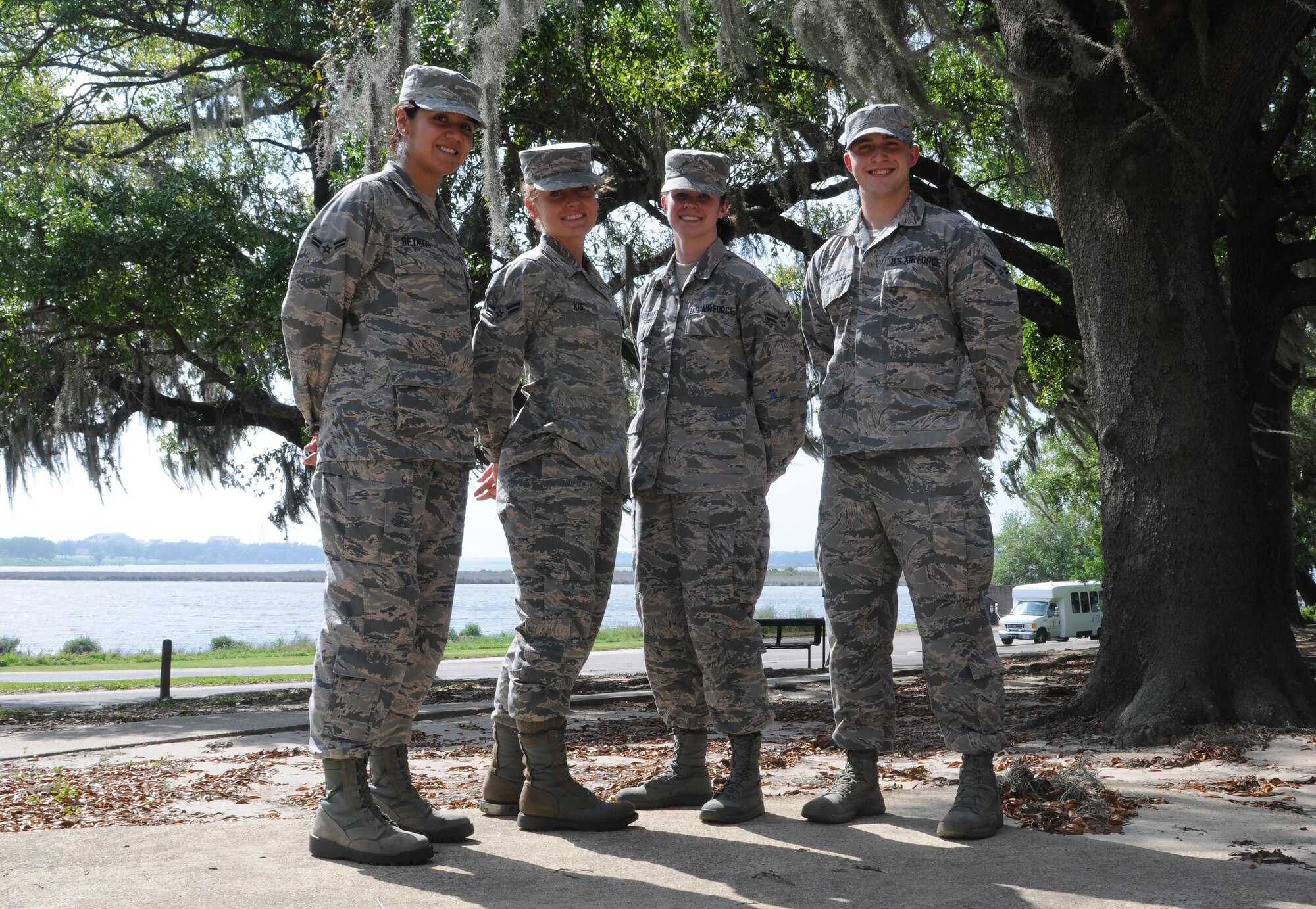 Senior Airman Below-the-Zone awardees pose for a group photo at Marina Park April 5, 2017, on Keesler Air Force Base, Miss.  Leadership from the 81st Training Wing selected four Airmen to advance to the rank of Senior Airman six months ahead of their peers! This selection was based off of their overall work ethic, leadership ability and significant impact to their unit’s mission. (U.S. Air Force photo by Senior Airman Holly Mansfield)