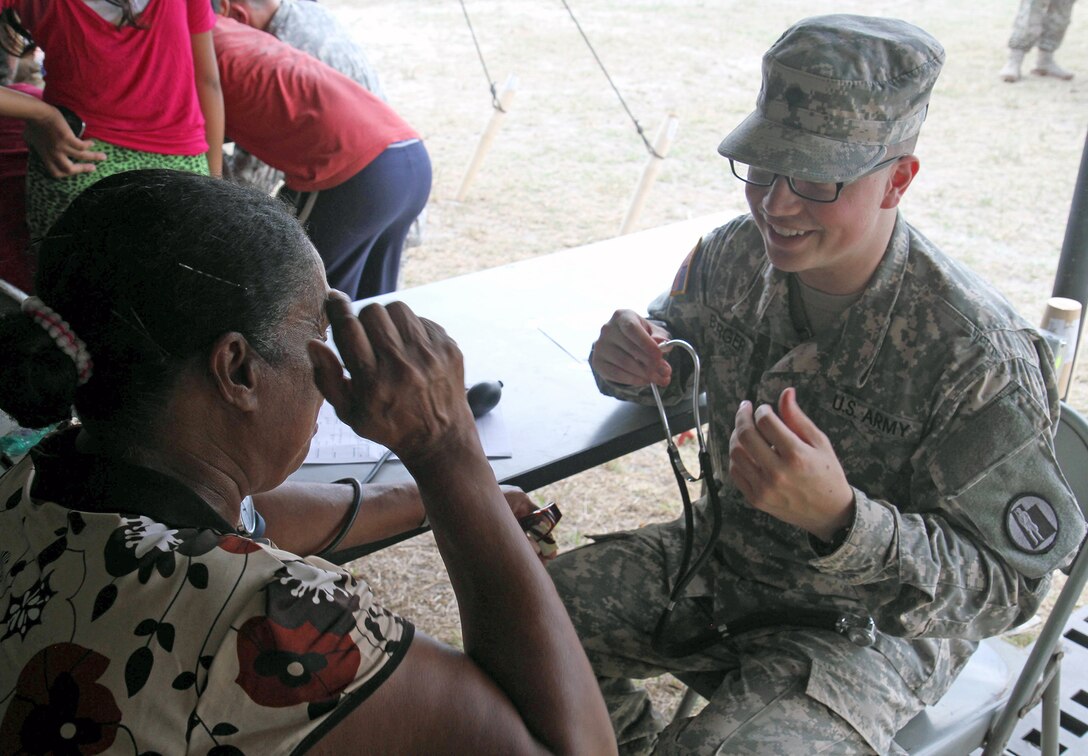 Spc. Braydon Berger, a combat medic assigned to Utah National Guard Medical Command, prepares to check vital signs on a local Belizean woman during a free medical event held in Ladyville, Belize, April 9, 2017, as a part of Beyond the Horizon 2017.  BTH 2017 is an on-going partnership exercise between the Government of Belize and U.S. Southern Command that will provide three free medical service events and five construction projects throughout the country of Belize from March 25 until June 17. (U.S. Army Photo by Staff Sgt. Fredrick Varney, 131st Mobile Public Affairs Detachment)