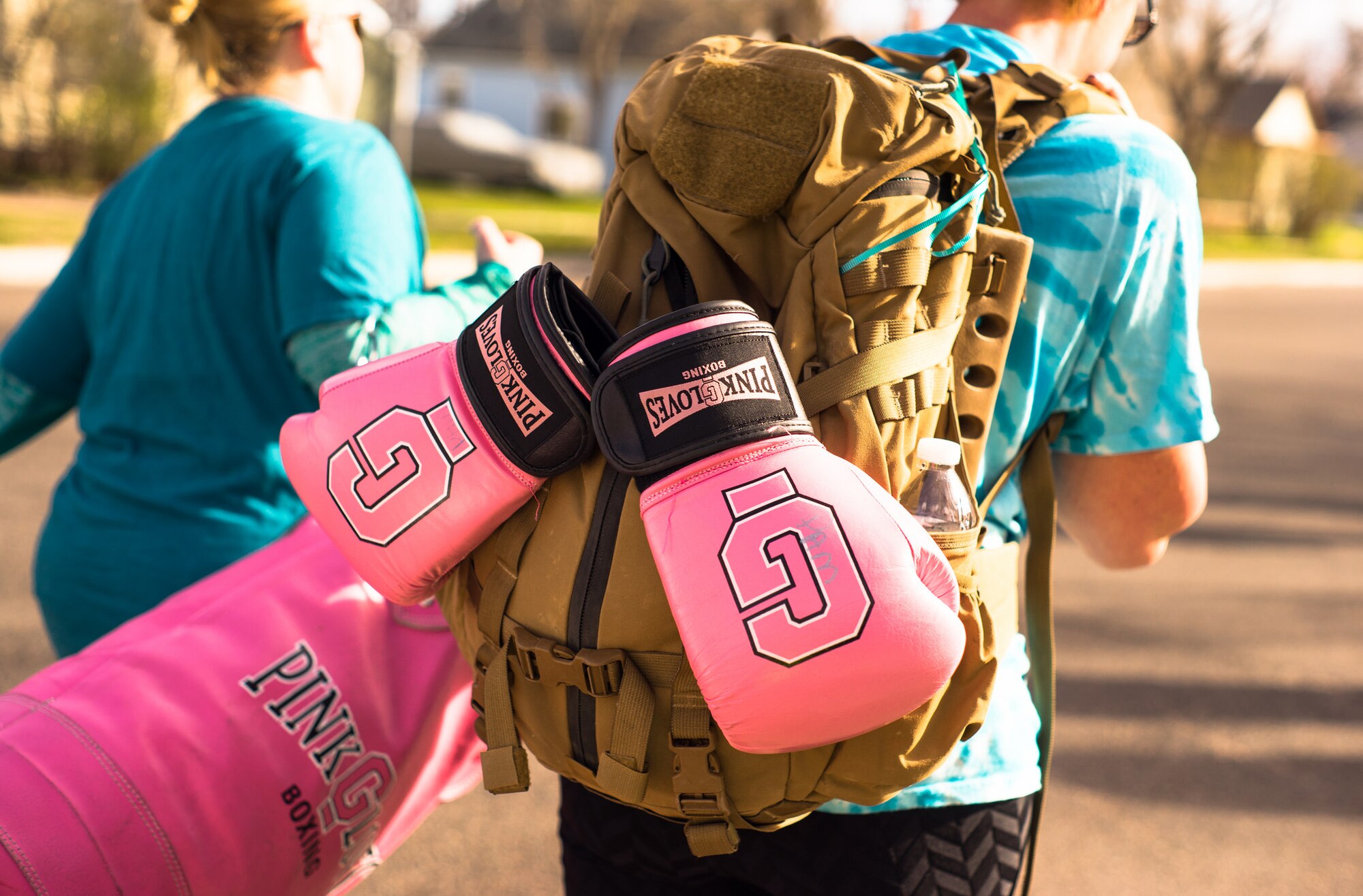 Women with Pink Gloves Boxing rucked with 40-pound ruck sacks during the 2017 Sexual Assault Awareness and Prevention 5k Ruck, Run, or Walk event on April 8, 2017 in Cheyenne, Wyoming.
  
This annual event is designed to bring awareness to sexual assault and show support to sexual assault victims. (Courtesy Photo by Daniel de La Fé)
