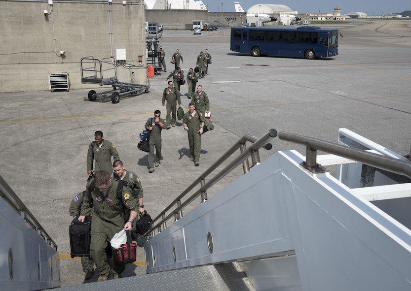 Aircrew from the 961st Airborne Air Control Squadron step toward an E-3 Sentry March 28, 2017, at Kadena Air Base, Japan. The 961st's airborne warning and control systems provide command and control for the Pacific theater, management of theater forces, and early warning of enemy actions during joint, allied, and coalition operations. (U.S. Air Force photo by Senior Airman John Linzmeier/released)