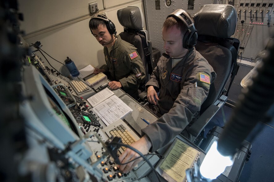 U.S. Air Force Staff Sgt. Anthony Lambrechts, 961st Airborne Air Control Squadron communication technician (left) and SSgt. Michael Burch, 961st AACS communication system operator, conduct a communications sweep March 28, 2017, during a training mission over the Pacific Ocean. Communications Airmen provide radio support to the aircrew, allowing for a secure means to communicate with partnered aircraft and various ground agencies. (U.S. Air Force photo by Senior Airman John Linzmeier/released)
