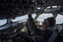 U.S. Air Force Maj. Victor Wadsley, 961st Airborne Air Control Squadron pilot, checks gauges on an E-3 Sentry March 28, 2017, over the Pacific Ocean. The radar and computer subsystems in the Sentry can gather and present broad and detailed battlefield information. (U.S. Air Force photo by Senior Airman John Linzmeier/released)
