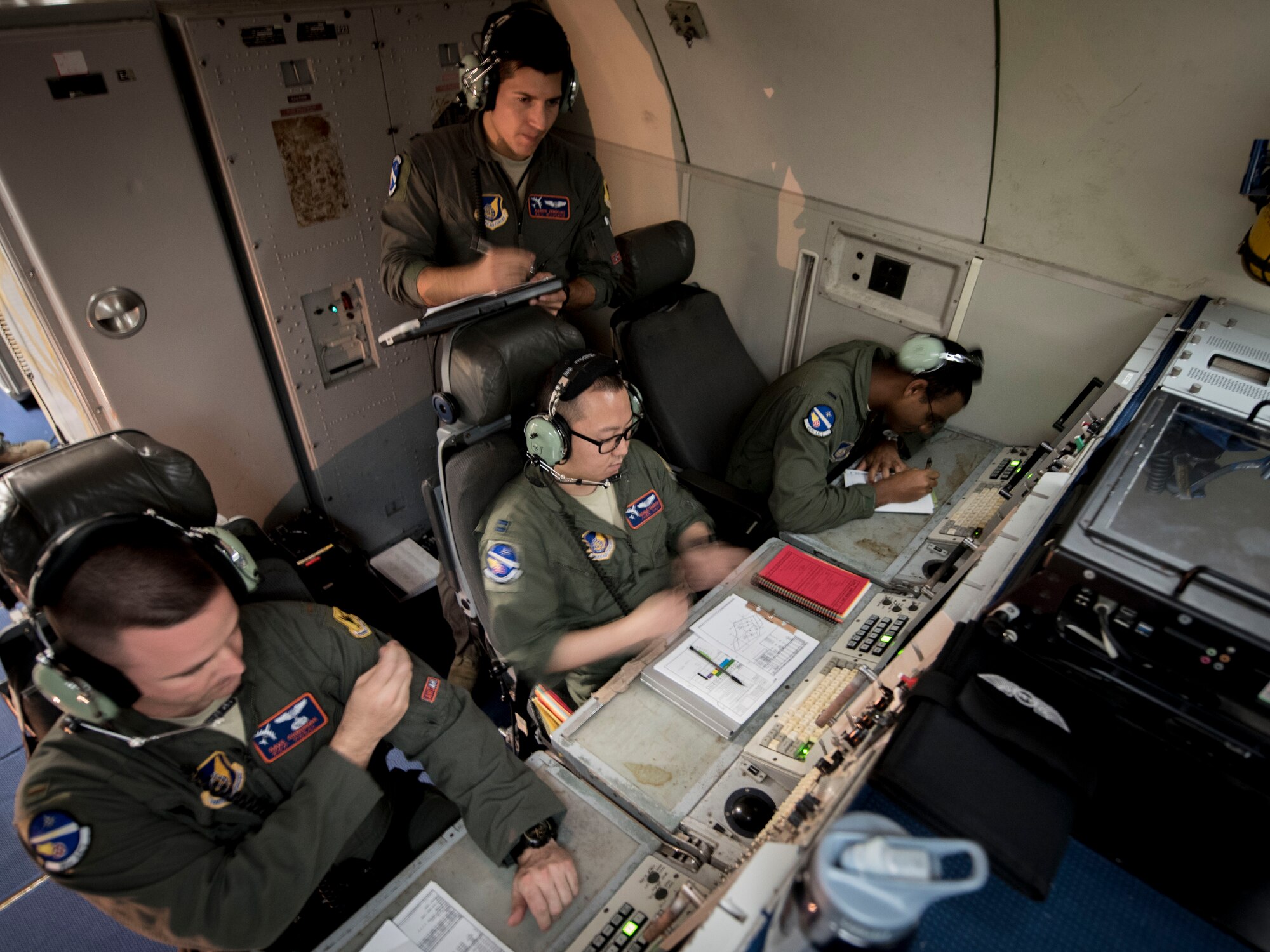 U.S. Air Force air weapons officers from the 961st Airborne Air Control Squadron communicate with F-15 Eagles from Kadena Air Base, Japan, March 28, 2017, during a training mission over the Pacific Ocean. The 961st conducts routine training with local fighter units to stay proficient at air combat operations. (U.S. Air Force photo by Senior Airman John Linzmeier/released)