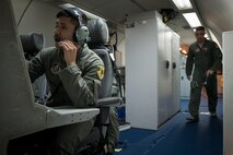 U.S. Air Force Airman 1st Class Favian Arteaga, 961st Airborne Air Control Squadron airborne surveillance technician (left), uses a communication system March 28, 2017, while flying in an E-3 Sentry over the Pacific Ocean. Airborne surveillance technicians make the initial identification of friend or foe aircraft and monitor their position. (U.S. Air Force photo by Senior Airman John Linzmeier/released)