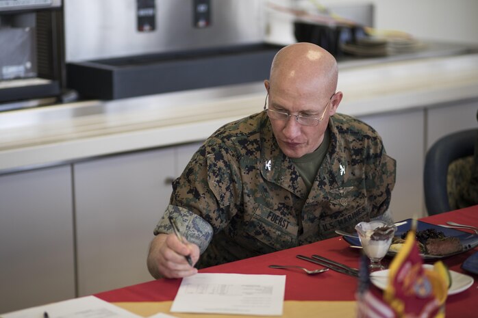 U.S. Marine Corps Col. Richard F. Fuerst, commanding officer of Marine Corps Air Station Iwakuni, fills out a judging form after tasting a dish during a Food Service Specialist of the Quarter competition at MCAS Iwakuni, Japan, April 13, 2017. The Food Service Specialist of the Quarter is a long-standing tradition within the Marine Corps food service community and is designed to allow food service Marines to showcase and demonstrate their individual culinary skills. (U.S. Marine Corps photo by Lance Cpl. Joseph Abrego