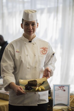 U.S. Marine Corps Cpl. Rebecca Messex, a food service specialist with Headquarters and Headquarters Squadron, poses for a photo with a meal she prepared during a Food Service Specialist of the Quarter competition at Marine Corps Air Station Iwakuni, Japan, April 13, 2017. Messex placed first in the competition and was selected for an opportunity to compete in the Marine Corps Installations Pacific Food Service Specialist of the Quarter Board to be held on April 19, 2017, in Okinawa.  (U.S. Marine Corps photo by Lance Cpl. Joseph Abrego)