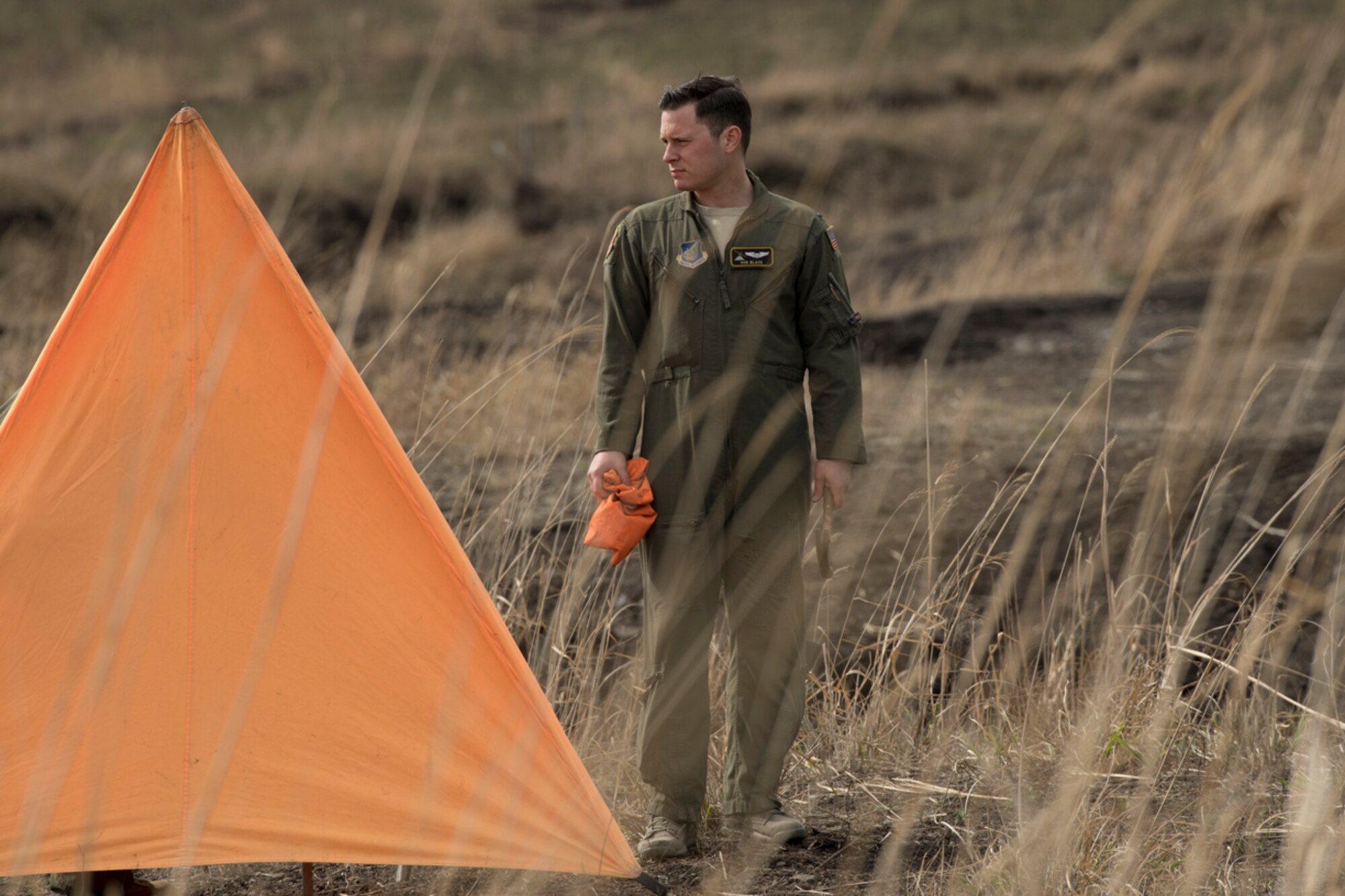 1st Lt. Robert Black, 36th Airlift Squadron C-130 pilot, sets up a marker for a drop zone while for supplies dropped from C-130H Hercules during a training mission at Combined Armed Training Center Camp Fuji,  April 12, 2017. Airmen from the 374th Logistics Readiness Squadron and Eagle airlifts with the 36th AS conducted mass containerized delivery system airdrop training. (U.S. Air Force photo by Yasuo Osakabe)