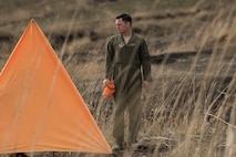 1st Lt. Robert Black, 36th Airlift Squadron C-130 pilot, sets up a marker for a drop zone while for supplies dropped from C-130H Hercules during a training mission at Combined Armed Training Center Camp Fuji,  April 12, 2017. Airmen from the 374th Logistics Readiness Squadron and Eagle airlifts with the 36th AS conducted mass containerized delivery system airdrop training. (U.S. Air Force photo by Yasuo Osakabe)
