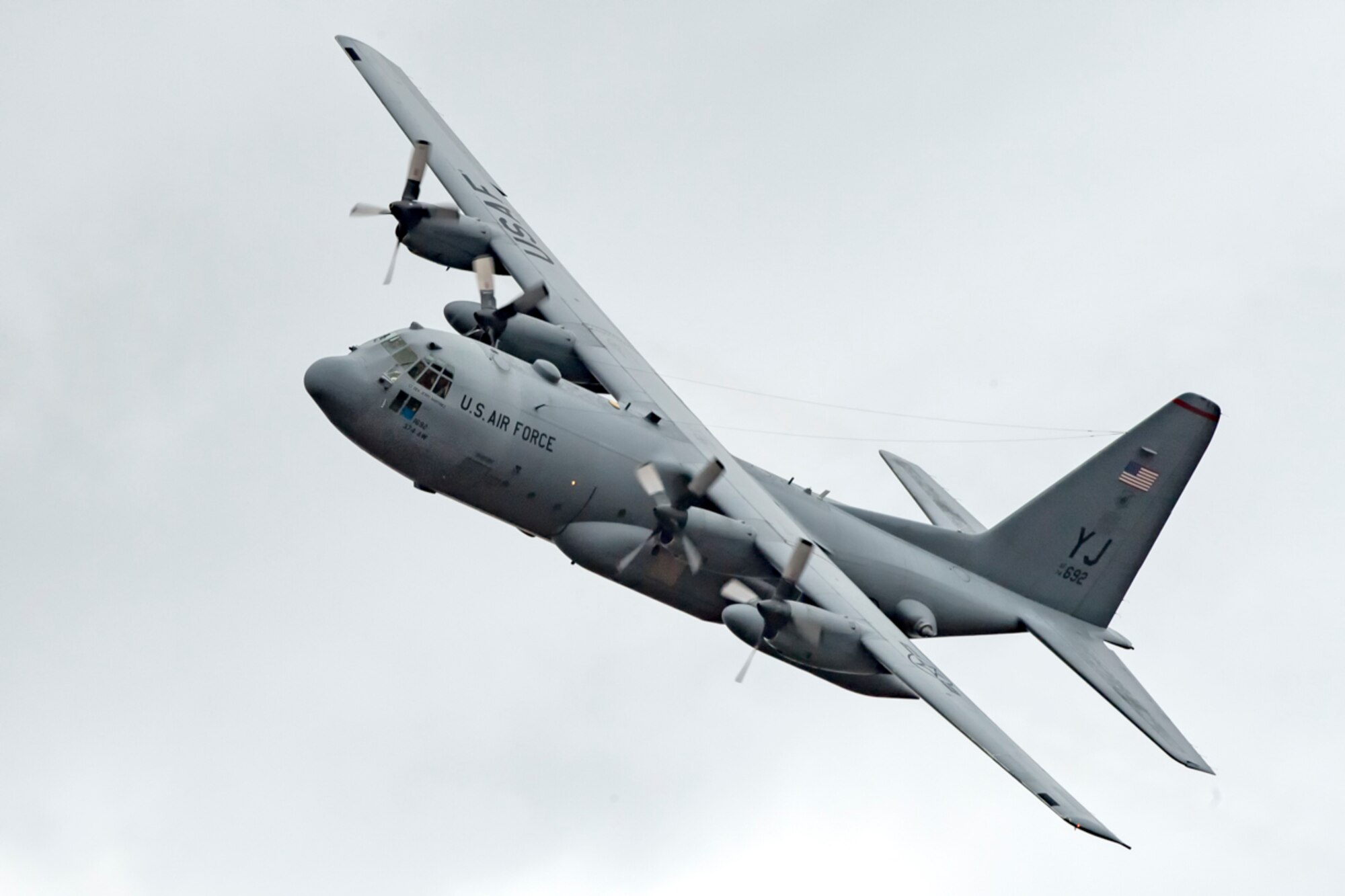 A C-130H Hercules assigned to the 36th Airlift Squadron flies over Combined Armed Training Center Camp Fuji, Japan, April 12, 2017, during a training mission. Airmen from the 374th Logistics Readiness Squadron and Eagle airlifts with the 36th AS conducted mass containerized delivery system airdrop training. (U.S. Air Force photo by Yasuo Osakabe)