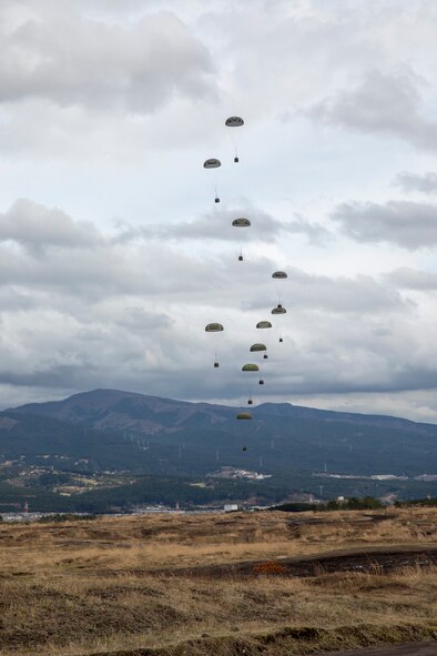 Containerized Delivery System bundles drop on a drop zone at Combined Armed Training Center Camp Fuji, Japan, April 12, 2017, during a training mission. Airmen with the 374th Logistics Readiness Squadron and Eagle airlifts with the 36th Airlift Squadron conducted mass CDS airdrop training. (U.S. Air Force photo by Yasuo Osakabe)