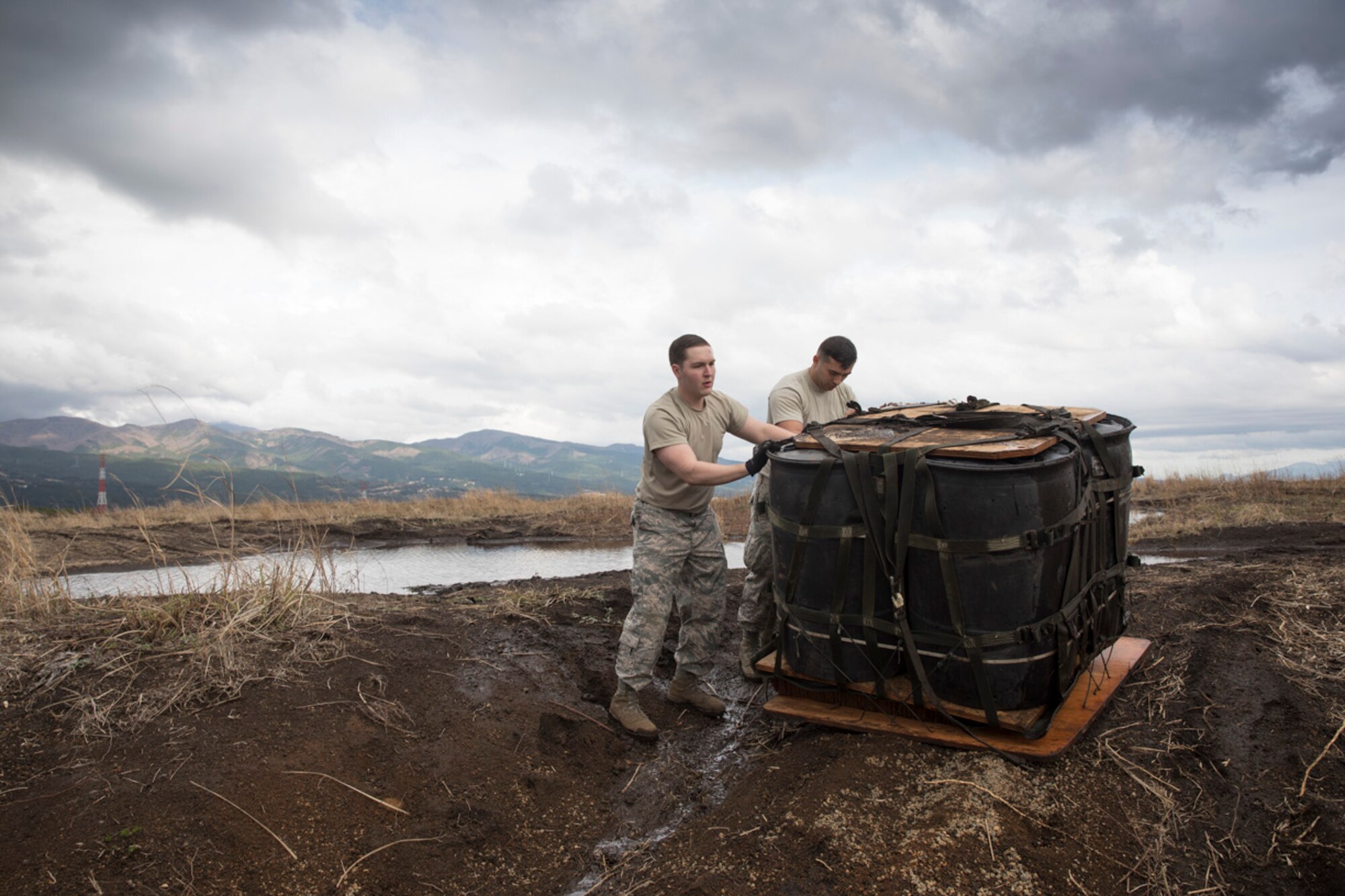 (Right to left) Airman 1st Class Dominic Pacheco, and Staff Sgt. William McAtee, both with the 374th Logistics Readiness Squadron combat mobility flight recovery team, pull a containerized delivery system bundle at Combined Armed Training Center Camp Fuji, Japan, April 12, 2017. Airmen with the 374th Logistics Readiness Squadron and Eagle airlifts with the 36th Airlift Squadron conducted mass CDS airdrop training. (U.S. Air Force photo by Yasuo Osakabe)