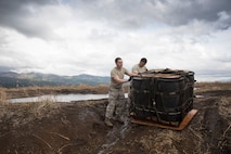 (Right to left) Airman 1st Class Dominic Pacheco, and Staff Sgt. William McAtee, both with the 374th Logistics Readiness Squadron combat mobility flight recovery team, pull a containerized delivery system bundle at Combined Armed Training Center Camp Fuji, Japan, April 12, 2017. Airmen with the 374th Logistics Readiness Squadron and Eagle airlifts with the 36th Airlift Squadron conducted mass CDS airdrop training. (U.S. Air Force photo by Yasuo Osakabe)
