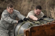 (Right to left) Staff Sgt. William McAtee and Tech. Sgt. Daniel Blair, both with the 374th Logistics Readiness Squadron combat mobility flight recovery team, pulls a Containerized Delivery System bundle at Combined Armed Training Center Camp Fuji, Japan, April 12, 2017. Airmen with the 374th Logistics Readiness Squadron and Eagle airlifts with the 36th Airlift Squadron conducted mass CDS airdrop training. (U.S. Air Force photo by Yasuo Osakabe)