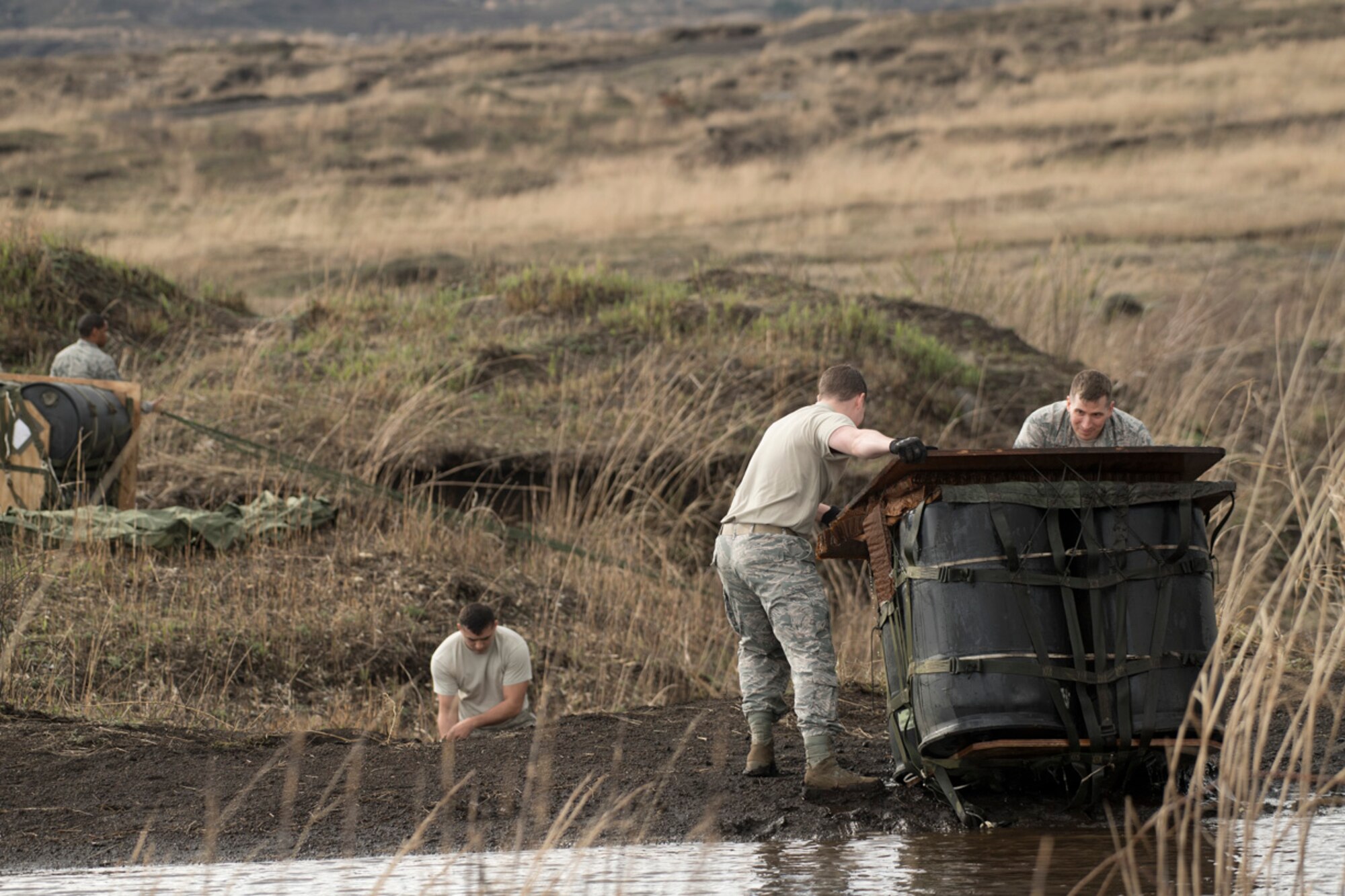 Airmen with the 374th Logistics Readiness Squadron combat mobility flight, recover a Containerized Delivery System bundle from a water at Combined Armed Training Center Camp Fuji, Japan, April 12, 2017. Airmen with the 374th Logistics Readiness Squadron and Eagle airlifts with the 36th Airlift Squadron conducted mass CDS airdrop training. (U.S. Air Force photo by Yasuo Osakabe)