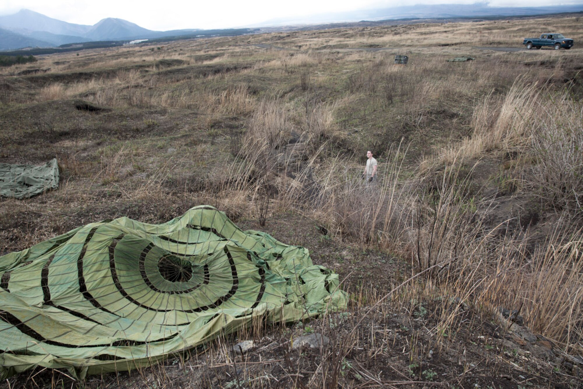 Airmen with the 374th Logistics Readiness Squadron combat mobility flight, recovers parachutes at Combined Armed Training Center Camp Fuji, Japan, April 12, 2017. Airmen with the 374th Logistics Readiness Squadron and Eagle airlifts with the 36th Airlift Squadron conducted mass CDS airdrop training. (U.S. Air Force photo by Yasuo Osakabe)