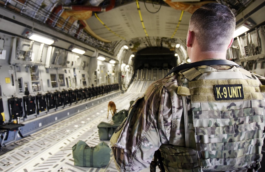 U.S. Air Force Staff Sgt. Timothy Glover, a military working dog handler with the 379th Expeditionary Security Forces Squadron, watches his military working dog Pprada sweep an aircraft during detection training at Al Udeid Air Base, Qatar, April 15, 2017. Glover and Pprada are one of several military working dog teams here supporting Operation Inherent Resolve. (U.S. Air Force photo by Senior Airman Cynthia A. Innocenti)