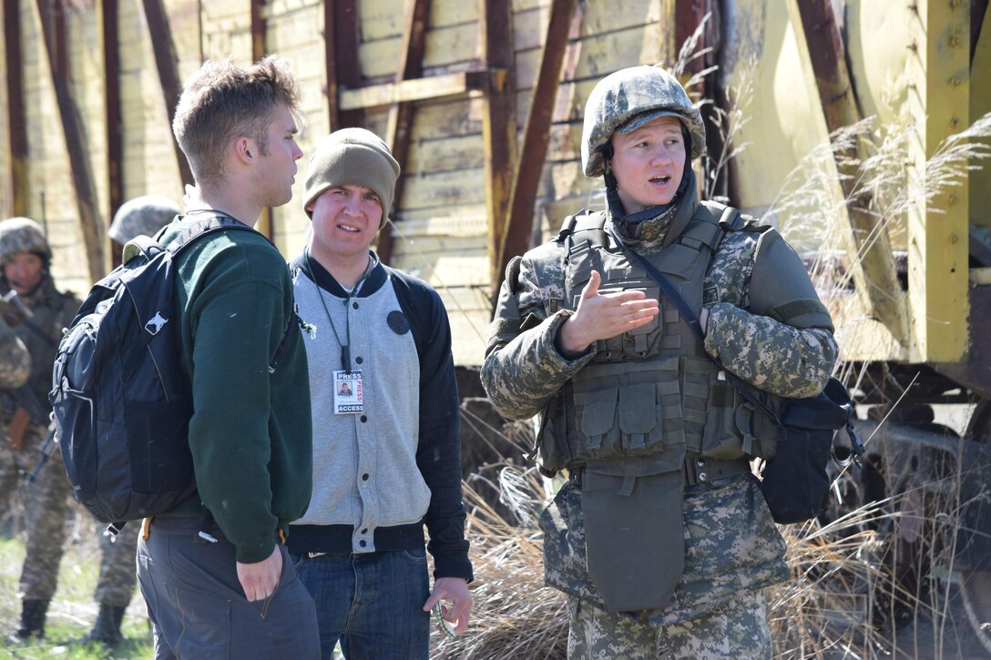 A Kazakhstani soldier from the Kazakhstan Peacekeeping Battalion escorts two media embed role players during a peacekeeping operations scenario for Steppe Eagle Koktem Apr. 10, 2017, at Illisky Training Center, Kazakhstan.