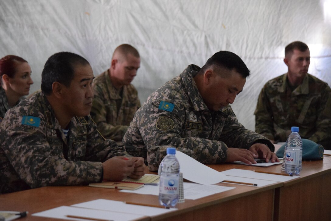 Lt. Col. Askar Kozhagaliyev, combat training directorate officer for Kazakhstan Land Forces Command, left, and Lt. Col. Bulat Dusembayev, commander of the Kazakhstan Peacekeeping Brigade, received the after action review brief on behalf of the Armed Forces of Kazakhstan on the last day of Steppe Eagle Koktem Apr. 11, 2017, at Illisky Training Center, Kazakhstan.