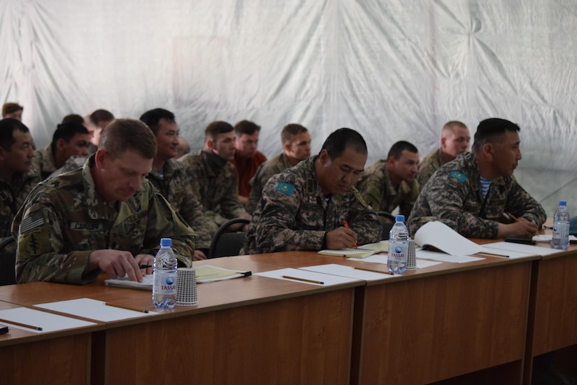 Officials from the U.S. Army, British Army and the Armed Forces of Kazakhstan listen to an after action review on the last day of Steppe Eagle Koktem Apr. 11, 2017, at Illisky Training Center, Kazakhstan.