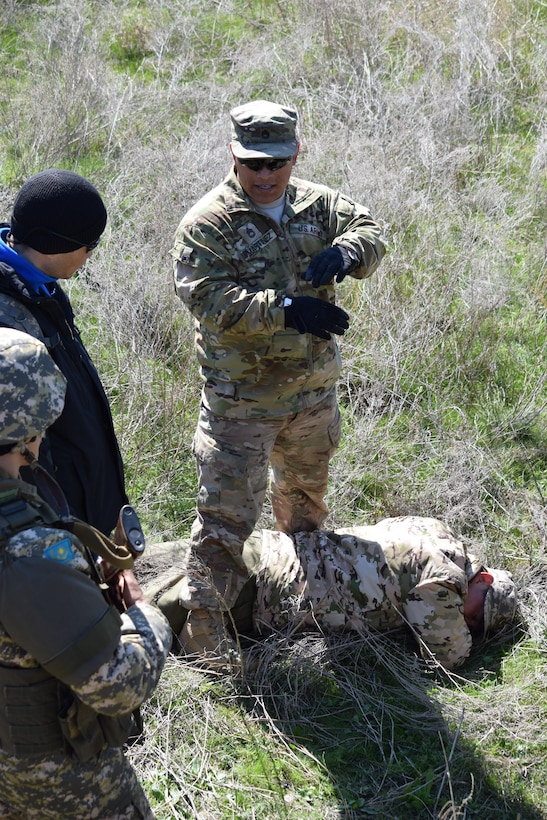 Sgt. 1st Class Javier Martinez, 6th Squadron, 9th Cavalry Regiment, answers questions about searching an enemy casualty during a scenario of the Steppe Eagle Koktem practical exercises Apr. 9, 2017, at Illisky Training Center, Kazakhstan.