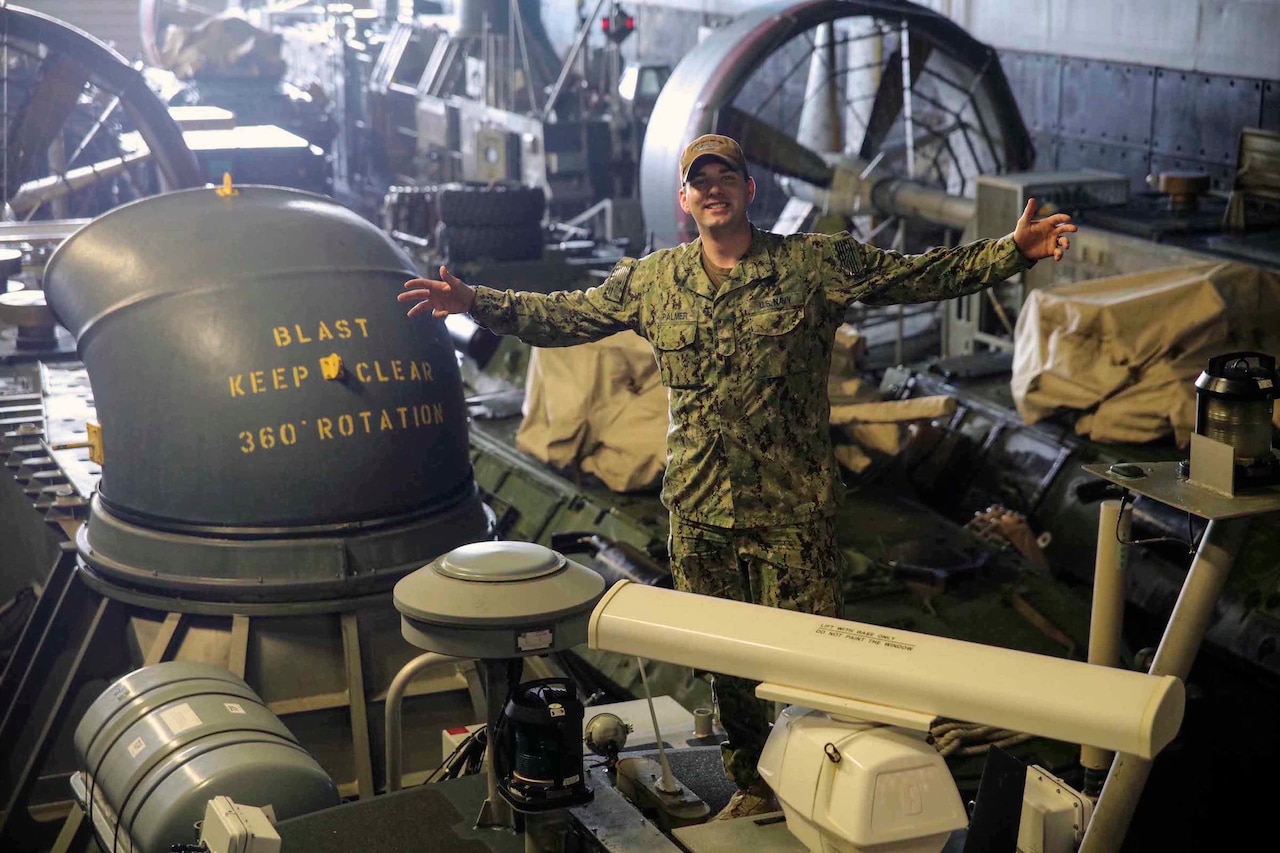 Navy Fireman Ian Palmer, assigned to Assault Craft Unit 4, poses on top of an air-cushion landing craft aboard the amphibious transport dock ship USS Mesa Verde deployed to the Mediterranean Sea, March 28, 2017. Mesa Verde is deployed with the Bataan Amphibious Ready Group to support maritime security operations and theater security cooperation efforts in the U.S. 6th Fleet area of operations. Navy photo by Petty Officer 2nd Class Brent Pyfrom