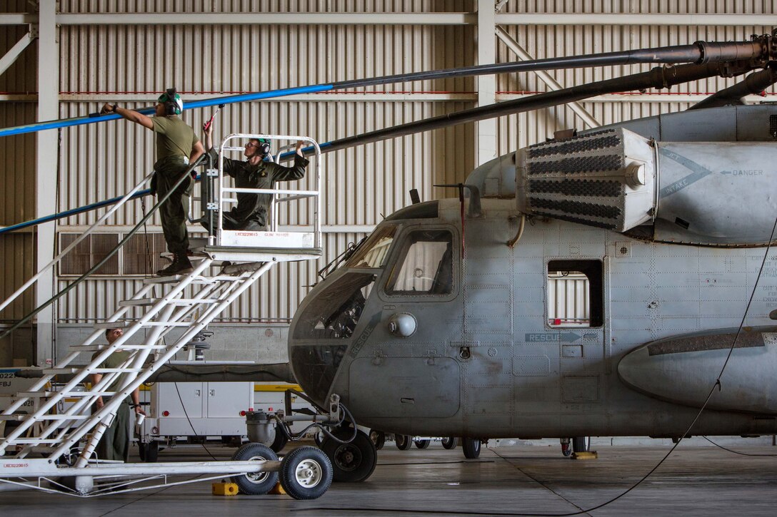 Marines paint rotor blades of a CH-53E Super Stallion helicopter during Weapons and Tactics Instructors Course 2-17 at Marine Corps Air Station Yuma, Ariz., April 14, 2017. Marine Corps photo by Cpl. Trever A. Statz 