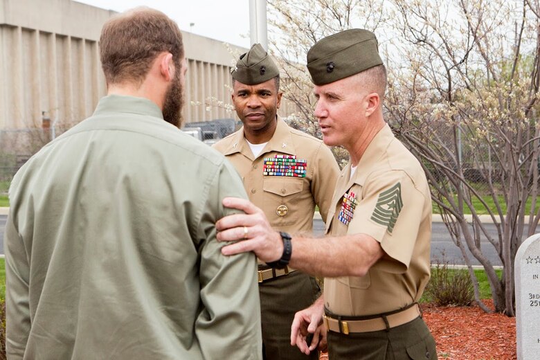 Sgt. Maj. William Grigsby (right), the sergeant major of Force Headquarters Group, Marine Forces Reserve, speaks with and congratulates Cpl. Nathan Bryson (left)  for being awarded the Navy and Marine Corps Medal in Brook Park, Ohio, April 13, 2017. A Marine Corps veteran, Bryson was awarded the medal for rescuing a man from a burning vehicle in 2014 while serving as a motor transport operator for Headquarters and Support Battalion, School of Infantry East, Camp Lejeune, North Carolina.  The Navy and Marine Corps Medal is awarded for acts of heroism despite personal risk and is the highest honor one can achieve for non-combat service. (U.S. Marine Corps Photo by Cpl. Dallas Johnson/Released)