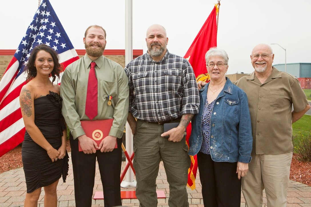 Cpl. Nathan Bryson poses for a photo with his girlfriend, father and grandparents after being awarded the Navy and Marine Corps Medal in Brook Park, Ohio, April 13, 2017. In 2014, Bryson and a fellow Marine helped rescue an elderly man from a burning vehicle. A Marine Corps veteran, Bryson most recently served as a motor transport operator for Headquarters and Support Battalion, School of Infantry East, Camp Lejeune, North Carolina. The Navy and Marine Corps Medal is awarded for acts of heroism despite personal risk and is the highest honor one can achieve for non-combat service. (U.S. Marine Corps Photo by Cpl. Dallas Johnson/Released)