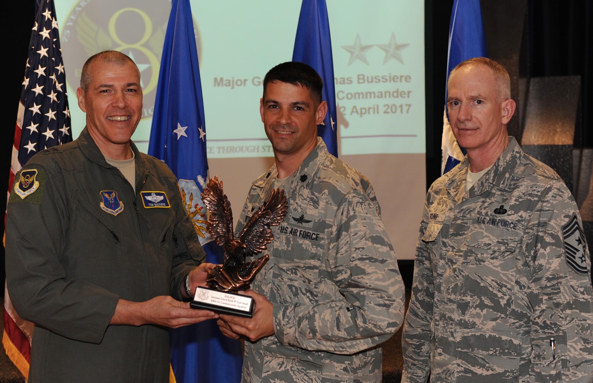 U.S. Air Force Maj. Gen. Thomas Bussiere, Eighth Air Force commander, left, and Chief Master Sgt. Alan Boling, Eighth Air Force command chief, far right, recognizes the 608th Air Communications Squadron on their selection as the Air Force Global Strike Command’s 2016 Air Force Lieutenant General Harold W. Grant Award during a Headquarters Eighth Air Force commanders call at Barksdale Air Force Base, La., April 12, 2017. The culmination of the unit’s efforts to contribute to and support vital air force missions and operations led to their selection. (U.S. Air Force photo by Senior Airman Erin Trower) 