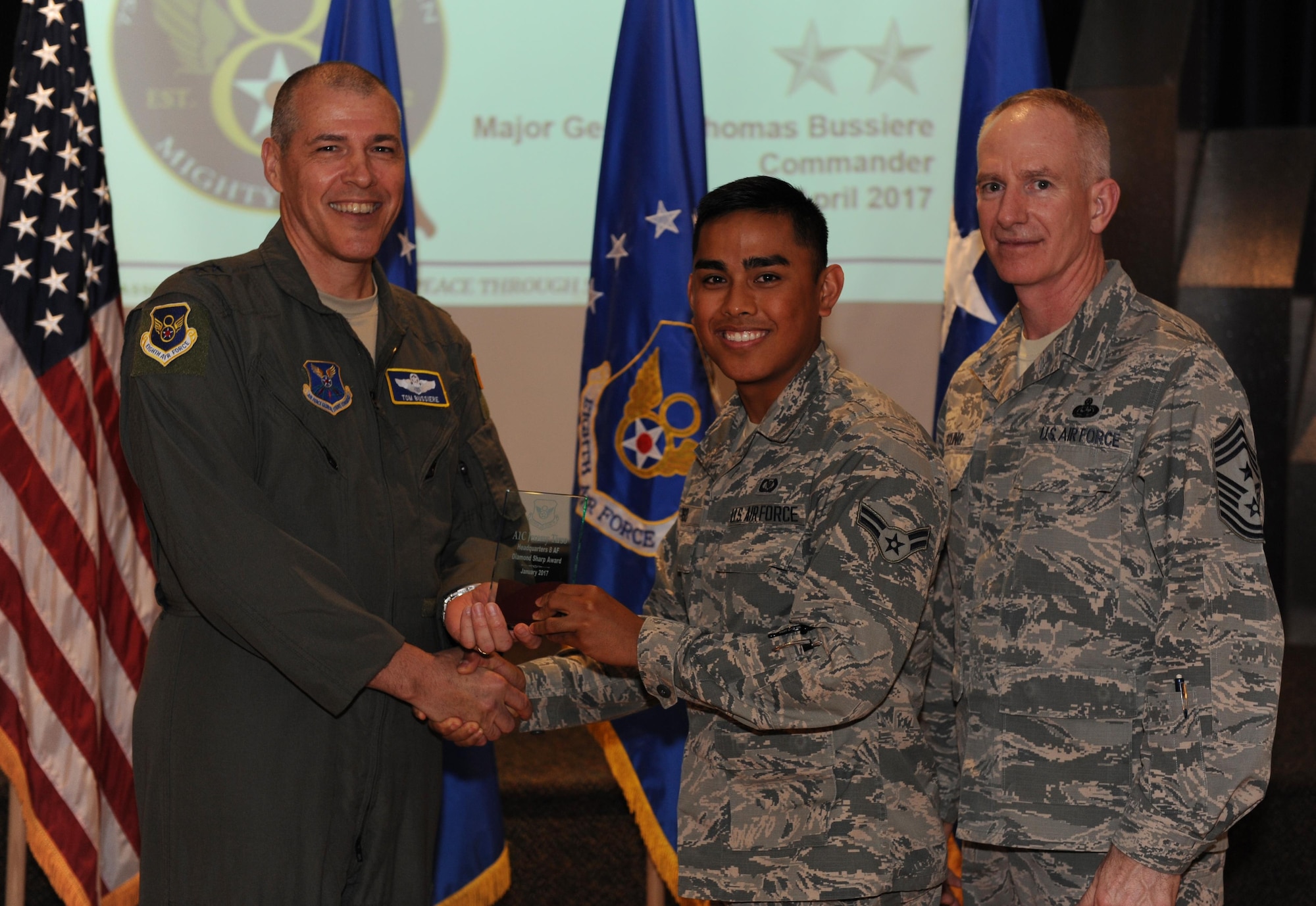 U.S. Air Force Maj. Gen. Thomas Bussiere, Eighth Air Force commander, left, and Chief Master Sgt. Alan Boling, Eighth Air Force command chief, far right, recognizes Airman 1st Class Jeremy Tirso, 608th Air Operations Center, as a Diamond Sharp Award winner for the month of January during a Headquarters Eighth Air Force commanders call at Barksdale Air Force Base, La., April 12, 2017. Various topics pertinent to the organization were discussed throughout the event, followed by a question and answer engagement session with the Airmen. (U.S. Air Force photo by Senior Airman Erin Trower)