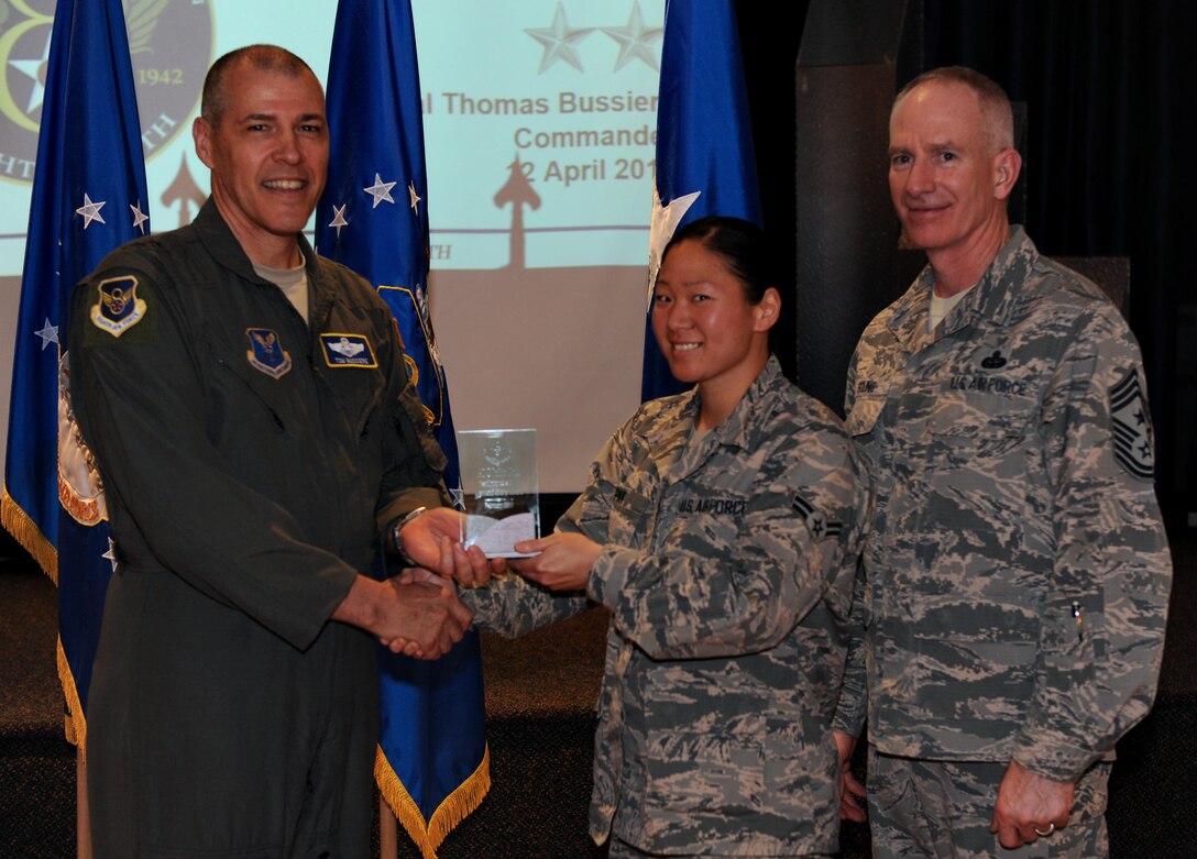 U.S. Air Force Maj. Gen. Thomas Bussiere, Eighth Air Force commander, left, and Chief Master Sgt. Alan Boling, Eighth Air Force command chief, far right, recognizes Airman 1st Class Julia Pak, 608th Air Operations Center, as a Diamond Sharp Award winner for the month of February during a Headquarters Eighth Air Force commanders call at Barksdale Air Force Base, La., April 12, 2017. Various topics pertinent to the organization were discussed throughout the event, followed by a question and answer engagement session with the Airmen. (U.S. Air Force photo by Senior Airman Erin Trower) 