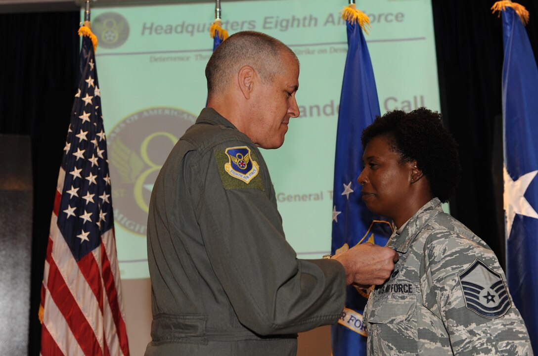 U.S. Air Force Maj. Gen. Thomas Bussiere, Eighth Air Force commander, presents the Air Force Achievement Medal to Master Sgt. Lakisha Taylor during a Headquarters Eighth Air Force commanders call at Barksdale Air Force Base, La., April 12, 2017. Taylor distinguished herself by outstanding achievement as noncommissioned officer in charge of administration, host nation coordination cell, 379th Air Expeditionary Wing, Al Udeid Air Base, Qatar. (U.S. Air Force photo by Senior Airman Erin Trower)