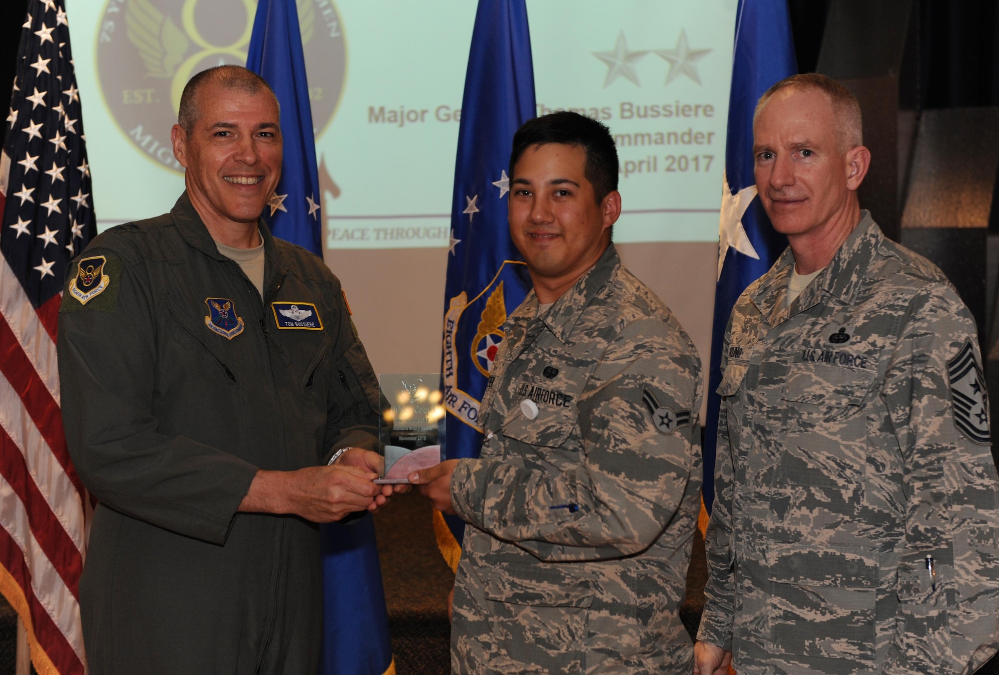 U.S. Air Force Maj. Gen. Thomas Bussiere, Eighth Air Force commander, left, and Chief Master Sgt. Alan Boling, Eighth Air Force command chief, far right, recognizes Airman 1st Class Sean Oczepek, 608th Air Communications Squadron, as a Diamond Sharp Award winner for the month of November during a Headquarters Eighth Air Force commanders call at Barksdale Air Force Base, La., April 12, 2017. Various topics pertinent to the organization were discussed throughout the event, followed by a question and answer engagement session with the Airmen. (U.S. Air Force photo by Senior Airman Erin Trower)