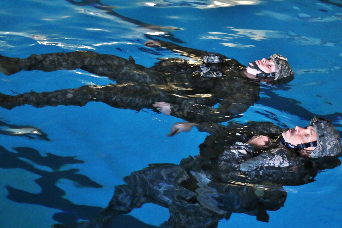 Soldiers conduct combat water survival training in a pool at Virginia Beach, Va., April 8, 2017. The soldiers are assigned to the Virginia National Guard's 2nd Squadron, 183rd Cavalry Regiment, 116th Infantry Brigade Combat Team. Army National Guard photo by Sgt. Amanda H. Johnson
