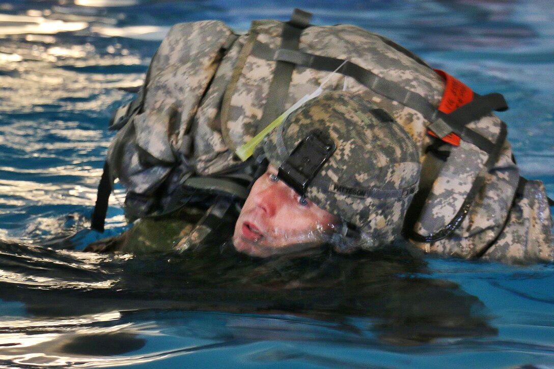 A soldier performs the side stroke during combat water survival training at Virginia Beach, Va., April 8, 2017. Army National Guard photo by Sgt. Amanda H. Johnson