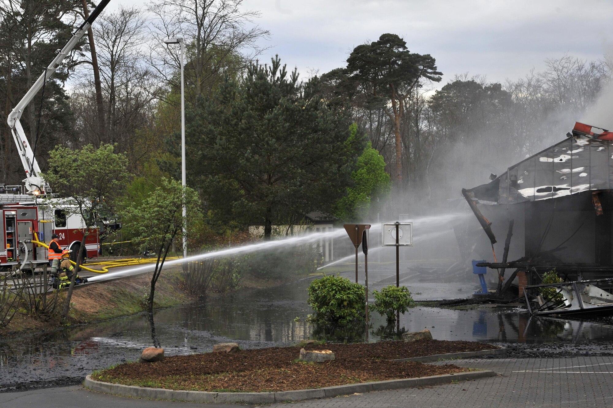 86th Civil Engineer Group Airmen combat flames of a fire at bldg. 1135, April 16, 2017 on Ramstein Air Base, Germany. According to base officials, the fire was contained and there was one minor injury, of a firefighter. The cause of the incident is under investigation. (U.S. Air Force photo by Airmen 1st Class D. Blake Browning)