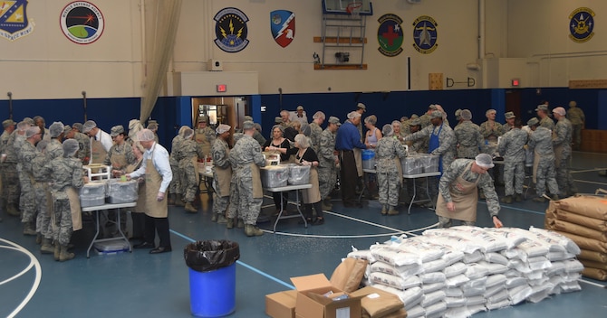 Airmen from Schriever Air Force Base, Peterson Air Force Base and Cheyenne Mountain Air Force Station prepare meals during a Kids Against Hunger volunteer event at Schriever Fitness Center, Tuesday, April 11, 2017. The mission of KAH, a humanitarian food-aid organization incorporated in 1999, is to significantly reduce the number of hungry children in the United States and to feed starving children throughout the world. (Air Force photo/Senior Airman Arielle Vasquez)