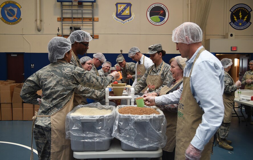 Airmen from Schriever Air Force Base, Peterson Air Force Base and Cheyenne Mountain Air Force Station prepare meals during a Kids Against Hunger volunteer event at Schriever Fitness Center, Tuesday, April 11, 2017. Volunteers prepared 40,000 meals, which will feed up to six people each. (Air Force photo/Senior Airman Arielle Vasquez)