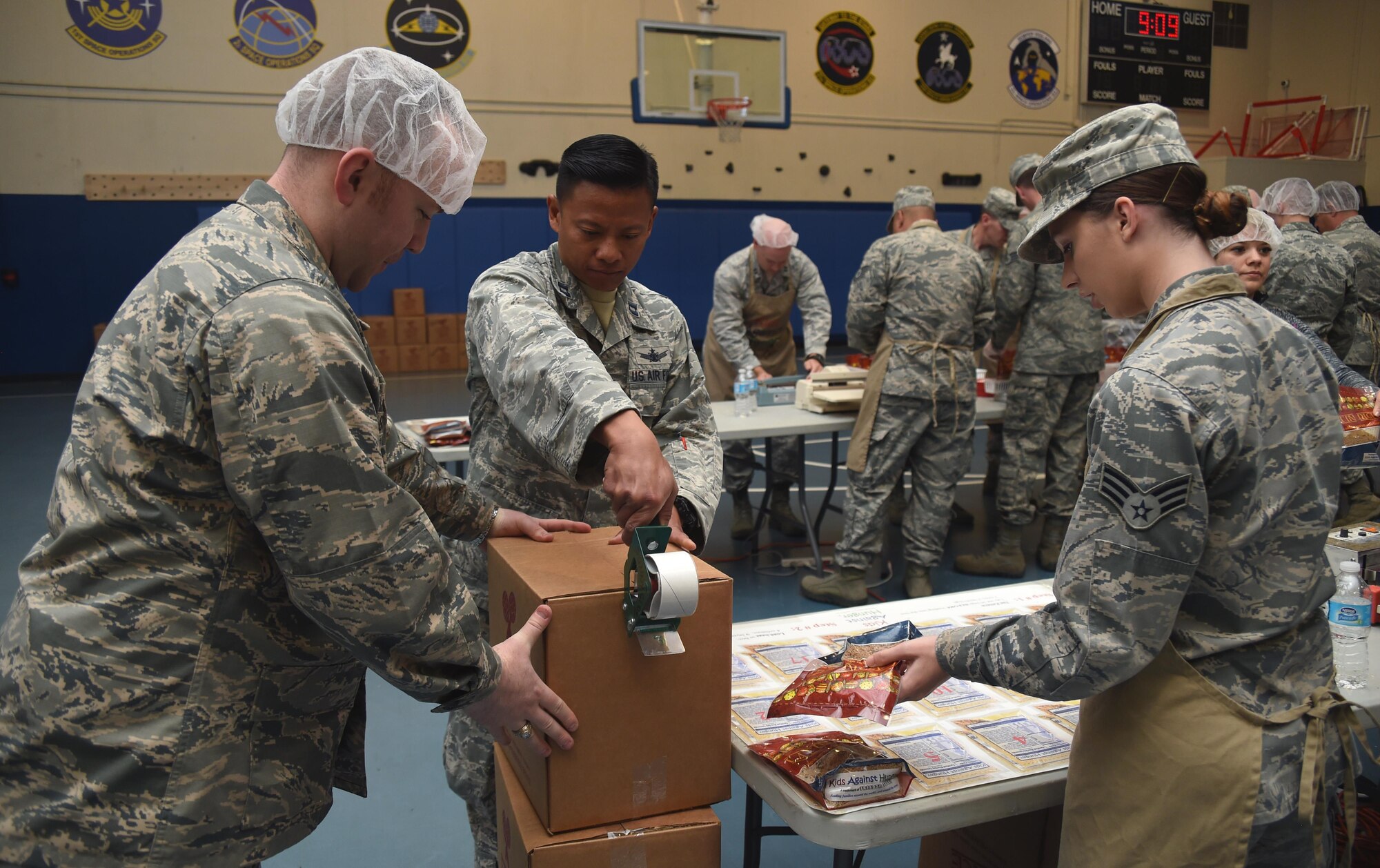 Airmen package boxes in an assembly line during a Kids Against Hunger volunteer event at Schriever Air Force Base, Colorado, Tuesday, April 11, 2017. Volunteers prepared 40,000 meals for the organization, and each meal feeds up to six people each.  (Air Force photo/Senior Airman Arielle Vasquez)