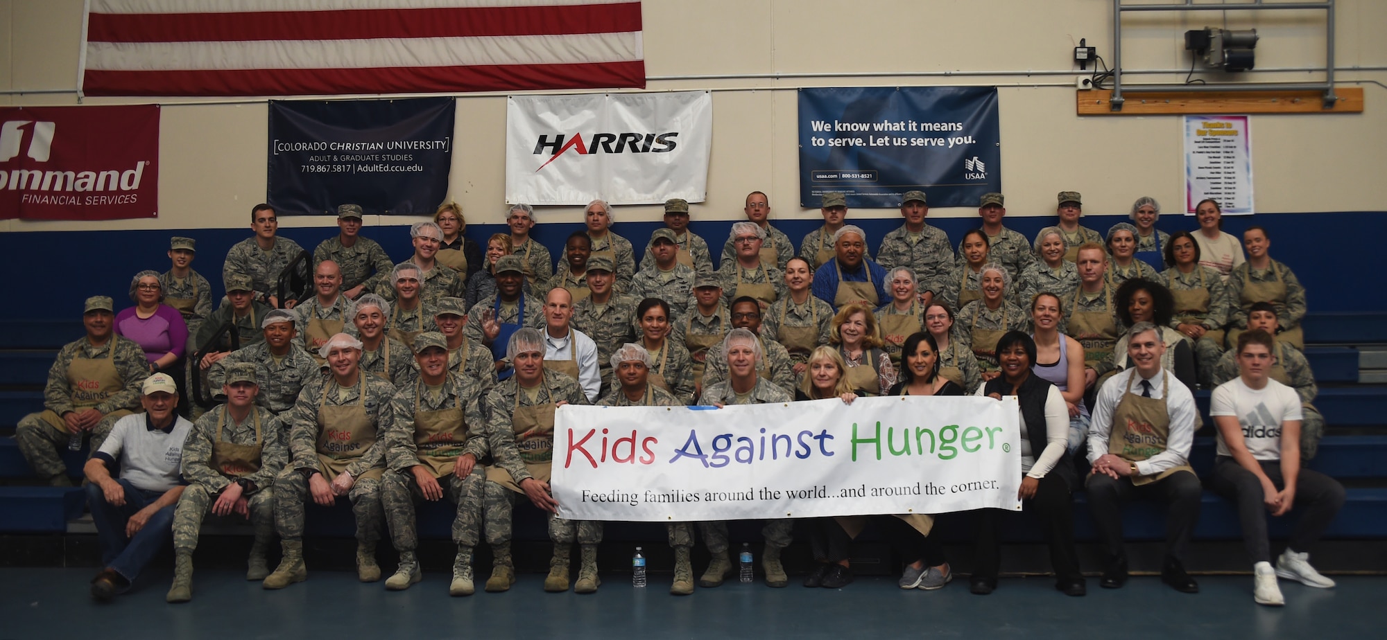 The first group of Kids Against Hunger volunteers gathered to package food at Schriever Air Force Base, Colorado, Tuesday, April 11, 2017. Volunteers with Schriever Air Force Base, Peterson Air Force Base and Cheyenne Mountain prepared 40,000 meals during the event. (Air Force photo/Senior Airman Arielle Vasquez)