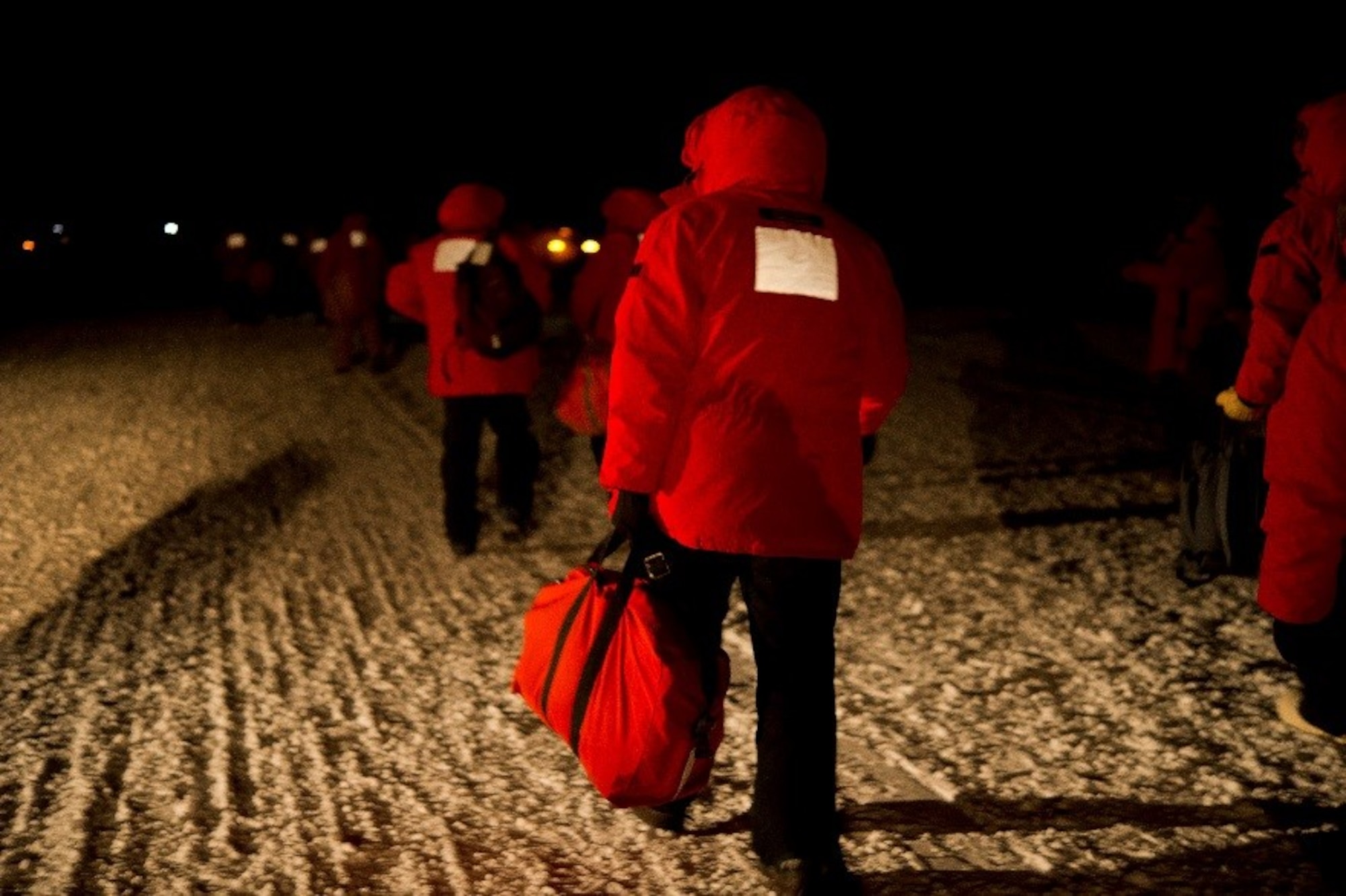 Passengers depart from a U.S. Air Force C-17 Globemaster III and make their way to McMurdo Station, Antarctica, during Operation Deep Freeze (ODF), July 15, 2016, at Pegasus Ice Runway. ODF is a joint operation between the U.S. Air Force, the National Science Foundation, and the Royal New Zealand Air Force. (U.S. Air Force Reserve photo by Staff Sgt. Madelyn McCullough)