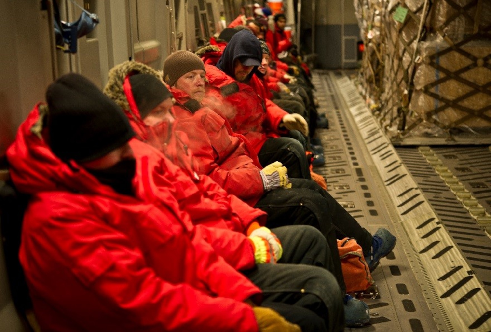 Passengers leaving Antarctica wait for cargo to finish being offloaded and onloaded onto a U.S. Air Force C-17 Globemaster III before takeoff during Operation Deep Freeze (ODF), July 15, 2016 at Pegasus Ice Runway, Antarctica. ODF is unlike any other U.S. military operation. Antarctica is the coldest, windiest, most inhospitable continent on the globe. Conditions are continuously monitored due to the unpredictable and quick-changing weather at the bottom of the world to ensure safety of aircraft, ships, cargo, passengers and crews while deployed in support of ODF. (U.S. Air Force Reserve photo by Staff Sgt. Madelyn McCullough)