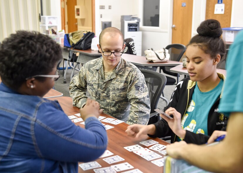 Senior Airman Nicholas Bacisin, a customer support technician here, plays a math-based card game and interacts with Inspiring Minds students during a study table, tutoring and fun session April 13, 2017. Youngstown Air Reserve Station partners with Inspiring Minds, a non-profit K-12 youth organization based in Warren, Ohio, to provide mentorship and represent the Air Force Reserve as a career option. Volunteers from YARS devote personal time to mentorship, tutoring and fun activities with the students several times throughout the school year. (U.S. Air Force photo/Eric White)