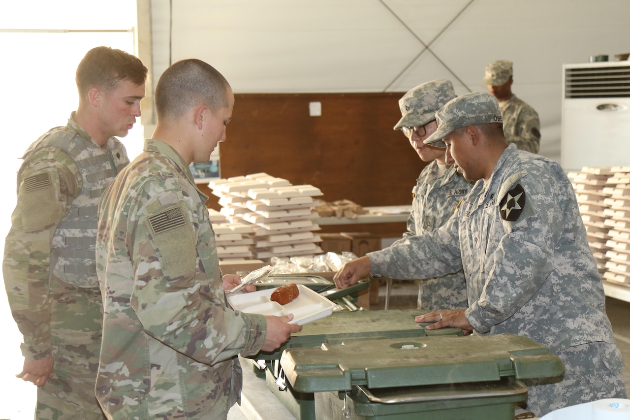 Two soldiers from the 571st Forward Support Company serve a hot meal at the 19th Expeditionary Sustainment Command Dining Facility at the 1st Republic of Korea Marine camp during Operation Pacific Reach Exercise 17 in Pohang, South Korea, April 14, 2017. Courtesy photo