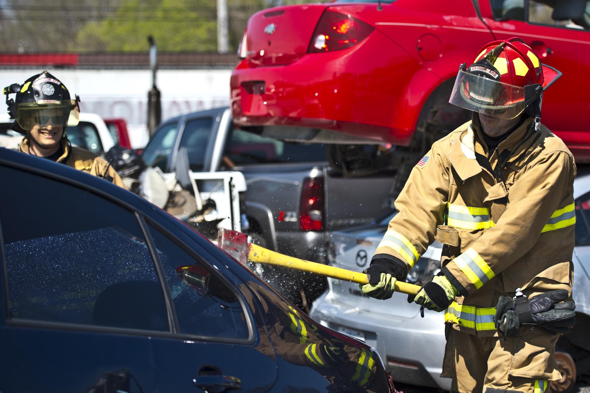 Gary Purcell and Robert Jacobs, Grissom firefighters, break the windows of a car during extrication training in Peru, Indiana, April 12, 2017. The Grissom fire department has an immediate response area around the base which can be extended if the emergency warrants it. (U.S. Air Force photo/Senior Airman Harrison Withrow)